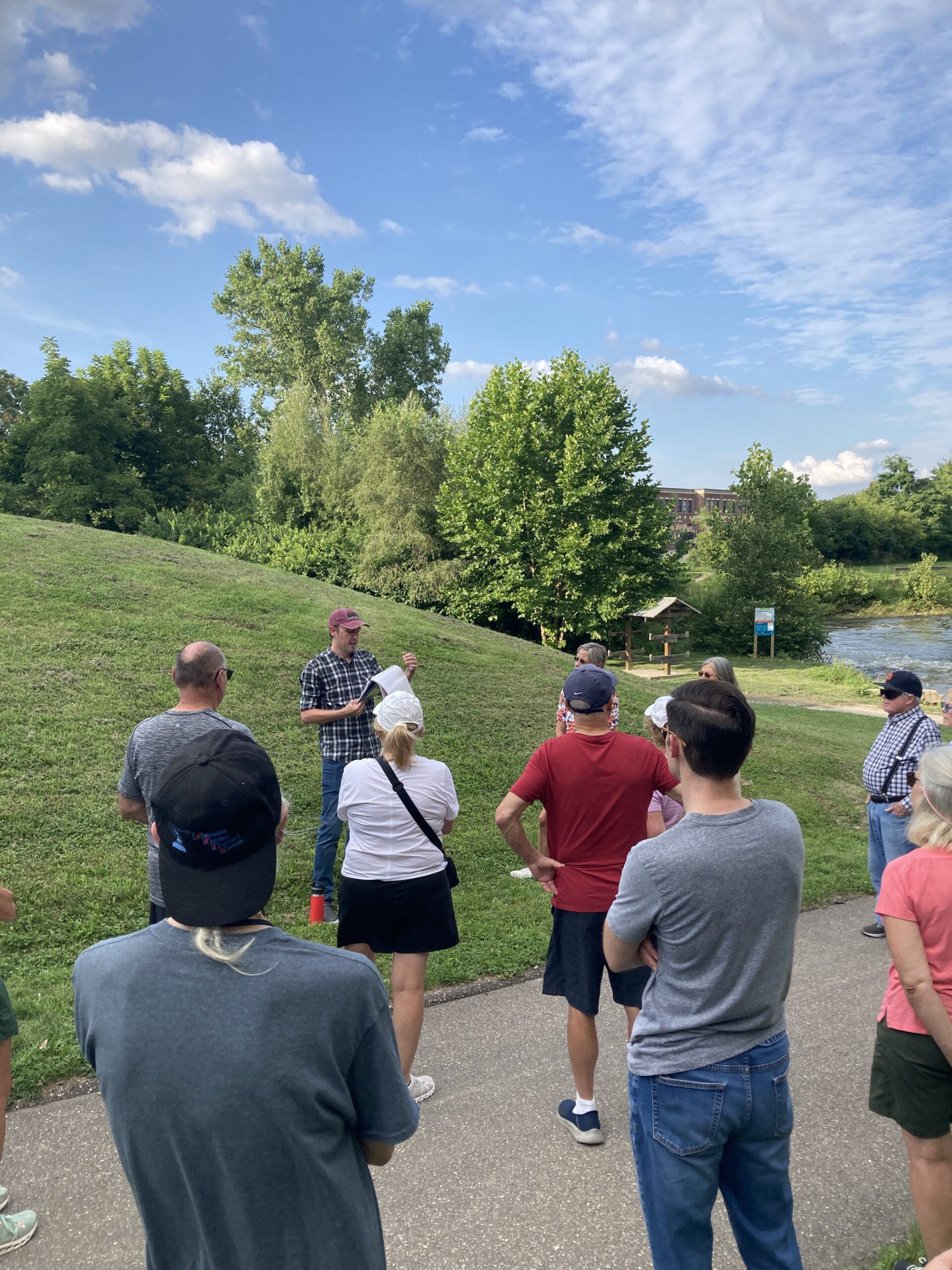 A color image of people on a historical walking tour with a tour leader.